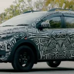 Nissan Gravite MPV in full camouflage seen from the side with roof rails and tall stance.