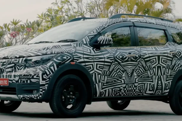 Nissan Gravite MPV in full camouflage seen from the side with roof rails and tall stance.