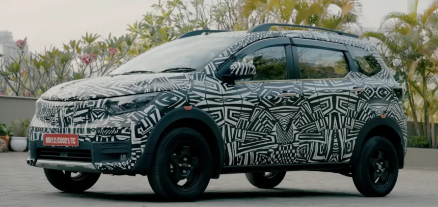 Nissan Gravite MPV in full camouflage seen from the side with roof rails and tall stance.